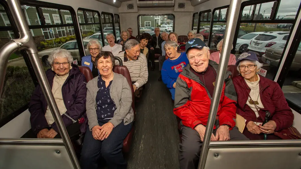 Seniors enjoying transportation on a community bus