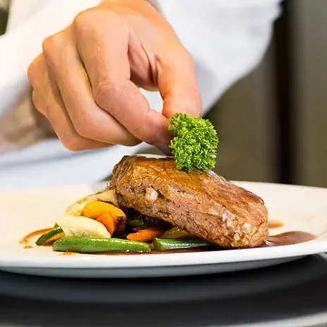 Hawthorn Senior Living Culinary Services, Chef Dressing a Dinner Plate